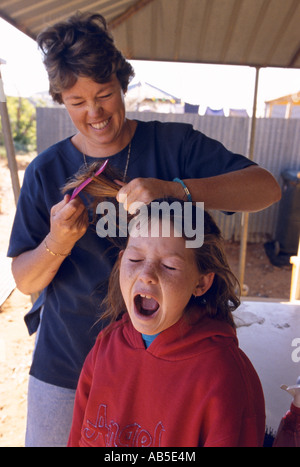 Mother doing daughter s hair, Langidoon Station, near Broken New South Wales, Australia, vertical, Stock Photo