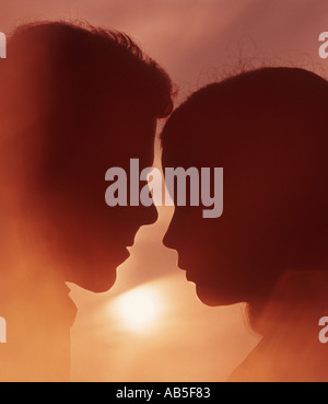 romantic couple embracing at sunset Stock Photo