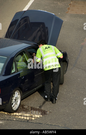 City of London AA breakdown patrol assisting stranded motorist sitting in car with bonnet up Stock Photo