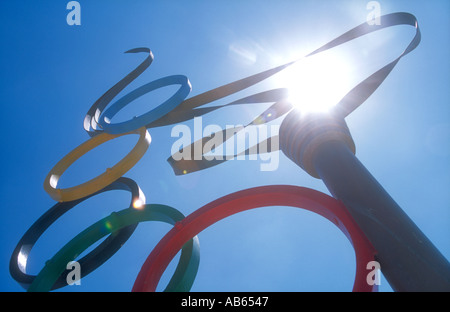 A sculpture of the Olympic Torch, the flame seemingly lit by the sun, with Olympic rings symbol, in Alimos, Athens, Greece. Stock Photo