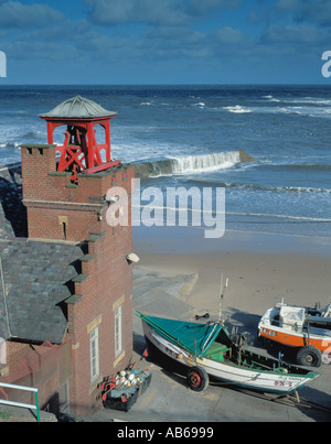 Old Lifeboat station and coble fishing boats, Cullercoats, Tyne and Wear, England, UK. Stock Photo