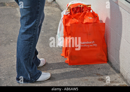 woman standing by shopping bags Stock Photo