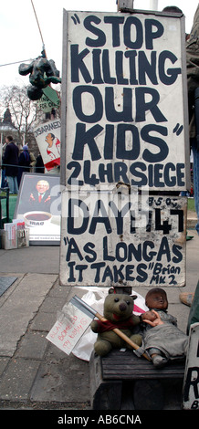 One of the slogans of Brian Hawes five year protest in Parliament Square outside Westminster. Stock Photo