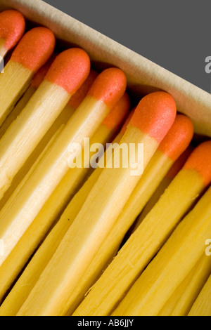 Red topped matches in matchbox close up Stock Photo