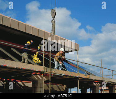Glaziers using a suction clamp to position a sheet of glass, Teesside Park, Stockton-on-Tees, Teesside, Cleveland, England, UK. Stock Photo