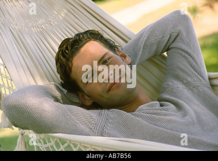 Man lying in hammock Stock Photo
