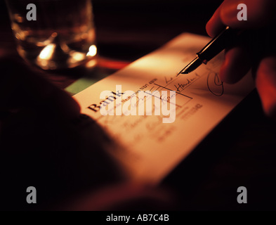 Writing cheque Stock Photo