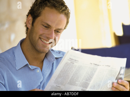 Man reading newspaper Stock Photo