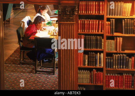 Two students in Dartmouth College Library with workbooks and pens under lamplight Stock Photo