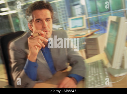 Businessman smoking a cigar Stock Photo