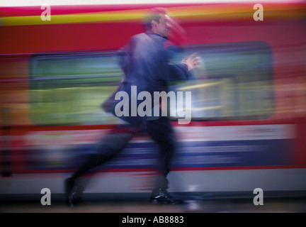 Man running after train Stock Photo