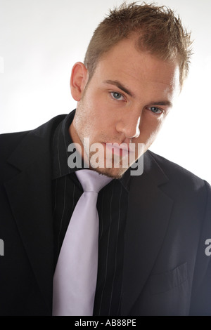 portrait of a blonde man, wearing a suit and a tie Stock Photo