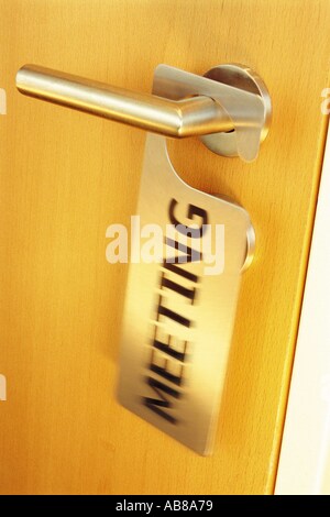 Meeting sign on a door handle Stock Photo