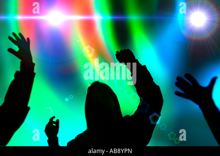 silhouette of  teen-age girls and boys at Rave dance concert Stock Photo