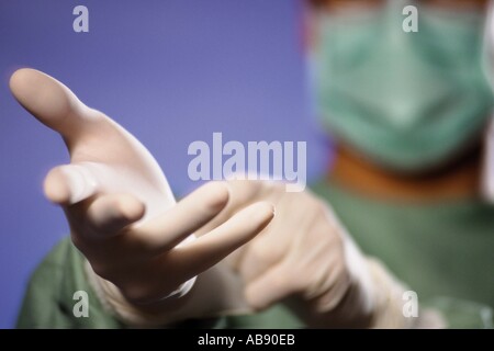 Surgeon putting on gloves Stock Photo