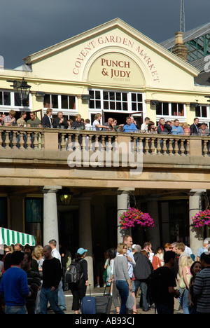 People on balcony of Punch and Judy pub in Covent Garden, London, England, UK Stock Photo