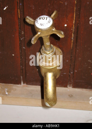 Old fashioned brass hot water tap Stock Photo