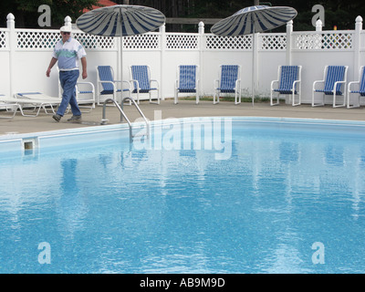 Man walking by Swimming Pool Stock Photo