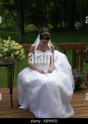 Bride Sitting on Porch in [Wedding Dress] Stock Photo