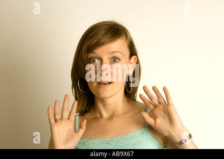 surprised or shocked expression on a young woman s face Stock Photo
