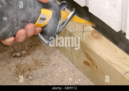Cutting a plank with a reciprocating  saw Stock Photo