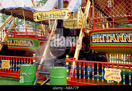 Yorky, a 1901 Savage steam engine powering and driving two Steam Yachts fairground rides, Carters Steam fair, Chiswick, London Stock Photo