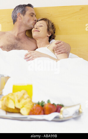 Man and woman having breakfast in bed Stock Photo