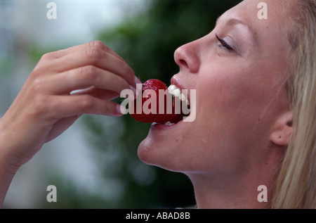 Girl eating strawberry Stock Photo