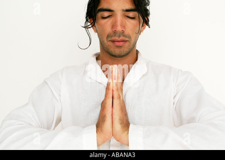 young man in prayer with closed eyes Stock Photo