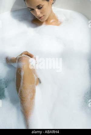 Woman taking bubble bath Stock Photo