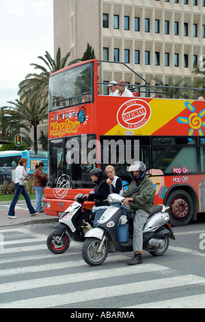 Open top tourbus for city sightseeing. Malaga southern Spain Europe EU. Motor scooters on the highway Stock Photo