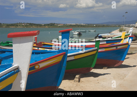 Portugal, the Algarve, Alvor, painted fishing boats on the harbour front. Stock Photo
