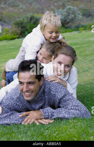 Family lying on the grass Stock Photo