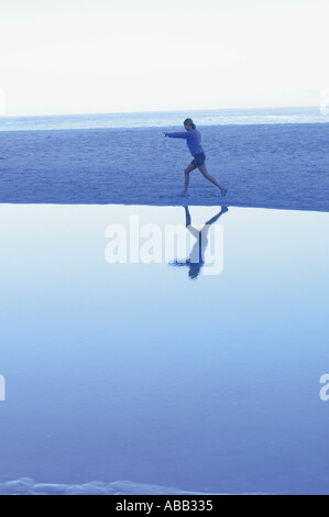 Woman exercising on beach Stock Photo