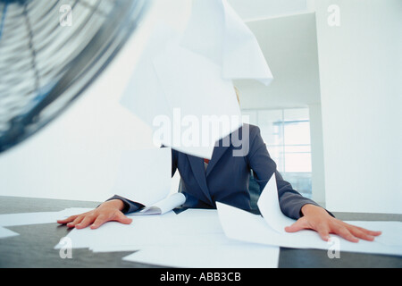 Businesswomans paperwork blowing in the air Stock Photo