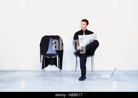 Man reading newspaper Stock Photo