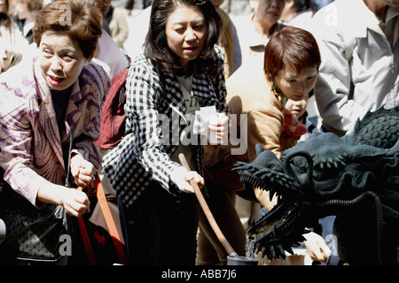 Domestic Japanese Tourists Drinking from a Dragon Spring, Kiyomizudera, Kyoto, Japan Stock Photo