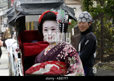 Geisha in Front of a Pulled Darriage During Cherry Blossom Festival in Kyoto Japan Stock Photo