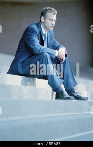 Businessman sitting on steps Stock Photo