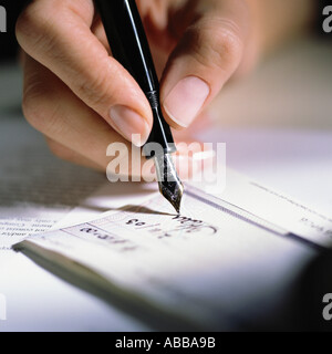 A hand holding a fountain pen Stock Photo