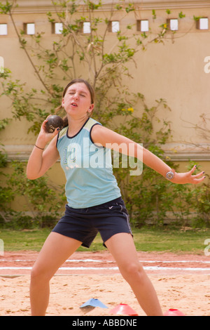 school girl throwing shot putt on school sports day Stock Photo