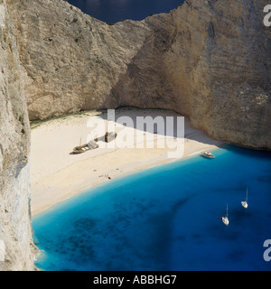 Classic white sand beach with high cliffs boats and deep blue sea at Wreck Beach Zakynthos Island The Greek Islands Greece Stock Photo