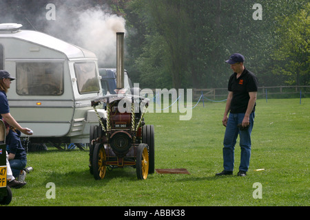 Man attending to raising steam on a model traction engine Stock Photo