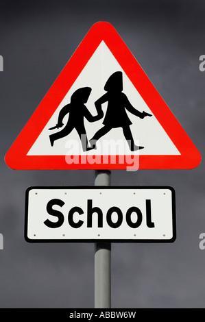 Road sign showing children in hoodies carrying weapons Stock Photo