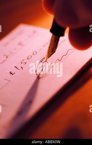 Person signing cheque Stock Photo