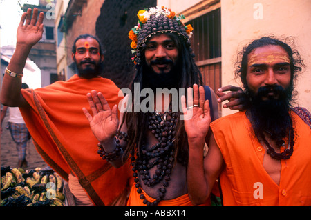 CMP70359 Three Indian Sadhu priests giving blessing in orange robes Stock Photo