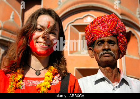 Portrait young western lady with red colour on her face beside Rajpute wearing red turban in front of the palace of the winds Stock Photo