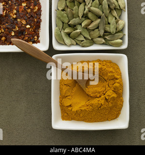Dried chillies cardamom pods and turmeric powder - one of a series of spice images Stock Photo