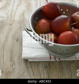 Red apples in colander Stock Photo