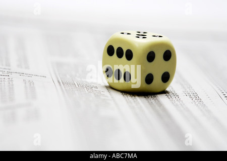 Dices lying on share price chart in a newspaper Stock Photo